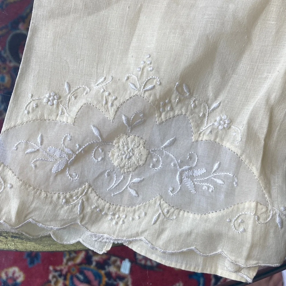 One fine linen embroidered tea towels. A muted butter yellow Vintage 1960s