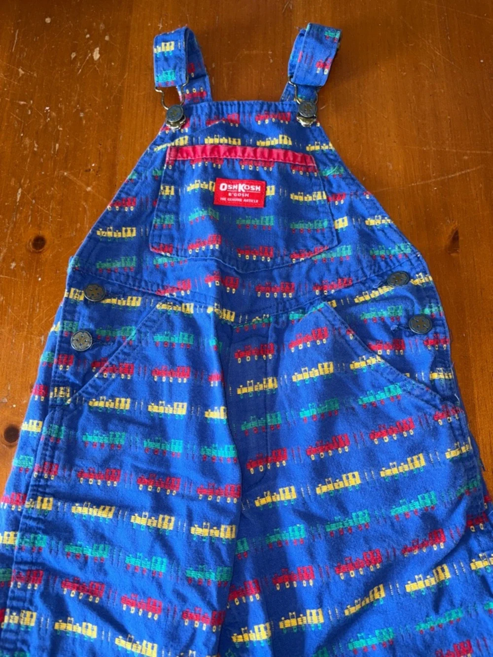 OshKosh B'gosh Bright Blue Overalls with Red, Yellow and Green Train Print