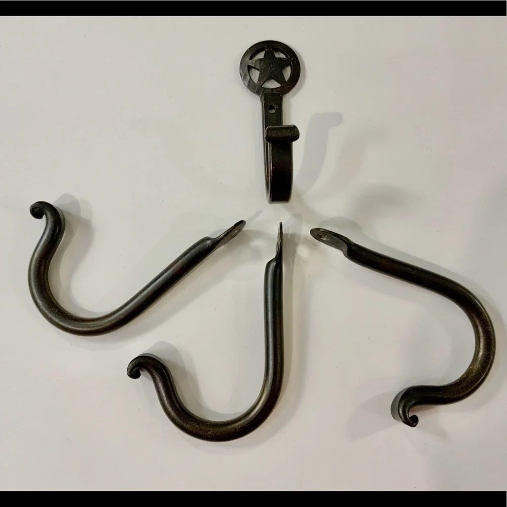 FOUR hand forged iron hooks.