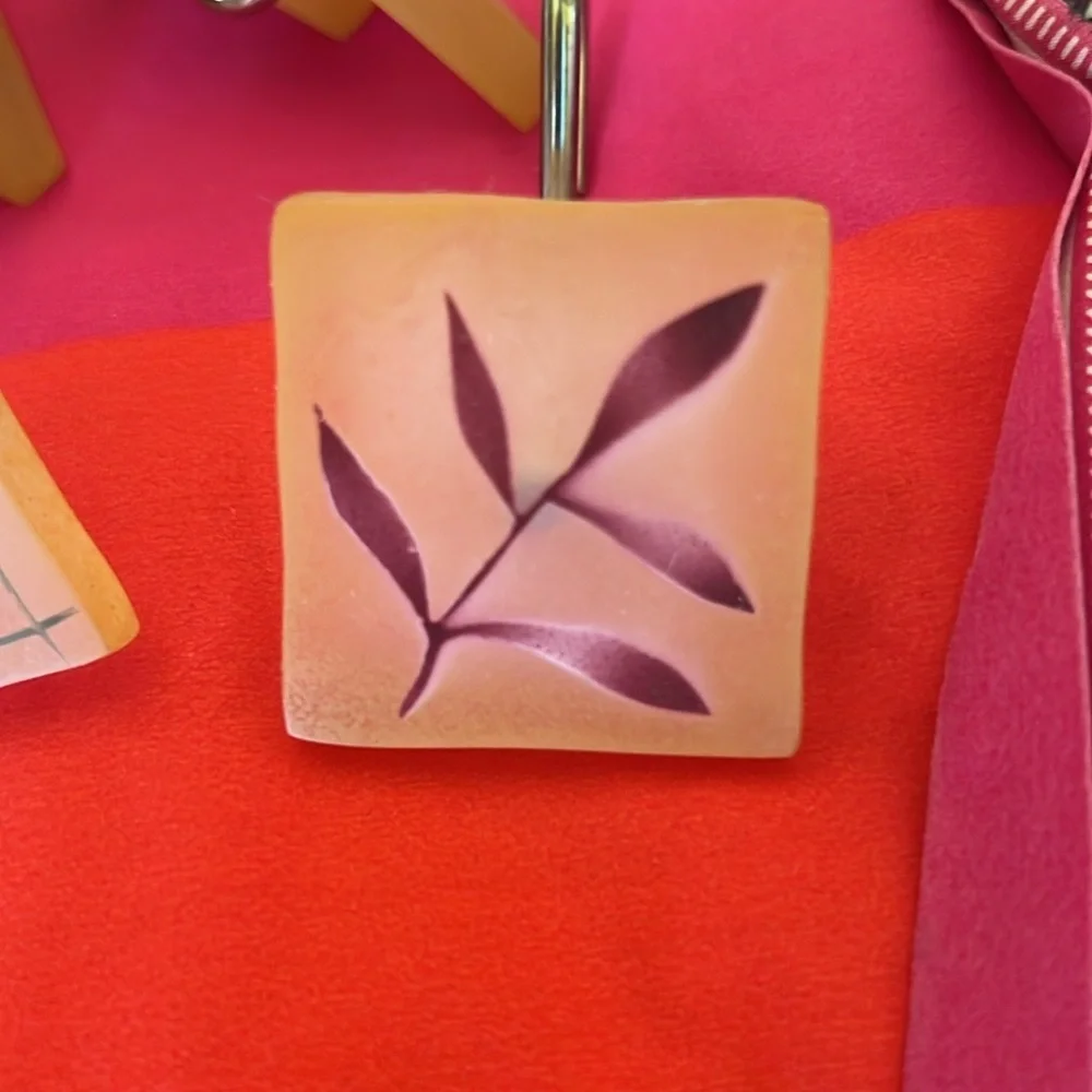 12 Shower curtain hooks. Resin . Green /maroon leaf pattern