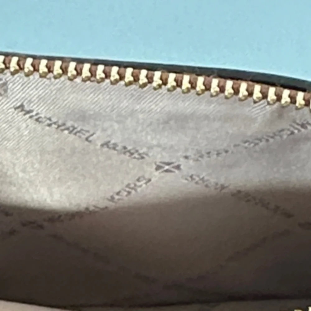 Michael Kors features tan wallet