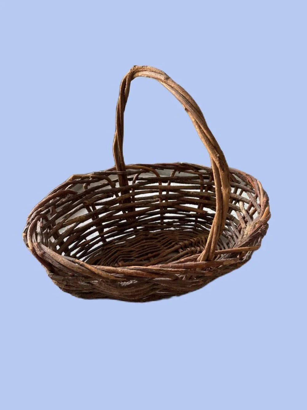Handwoven vintage twig gathering basket with handle.