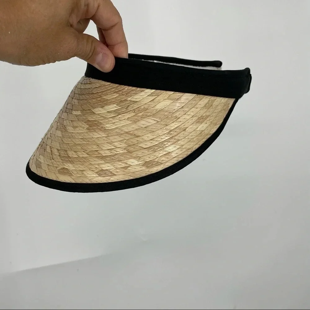 Straw visor with black trim.  Terry cloth lining
