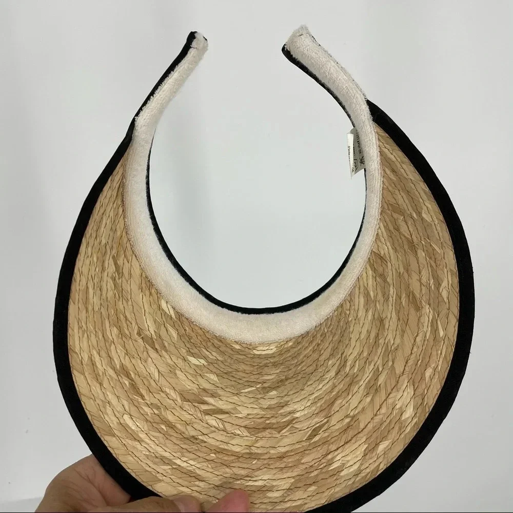 Straw visor with black trim.  Terry cloth lining