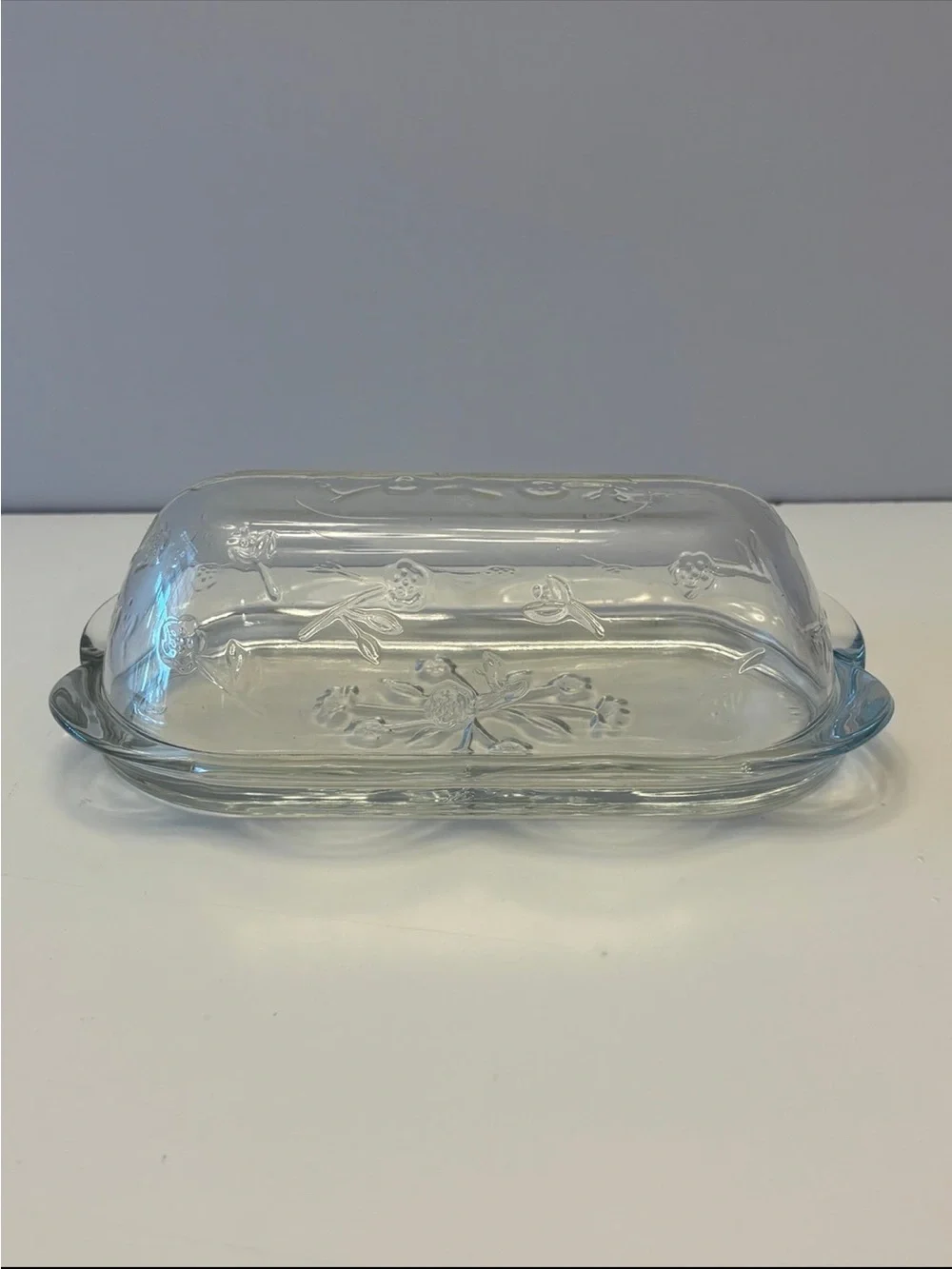 Anchor Hocking Savannah butter dish features a pressed clear glass design flower
