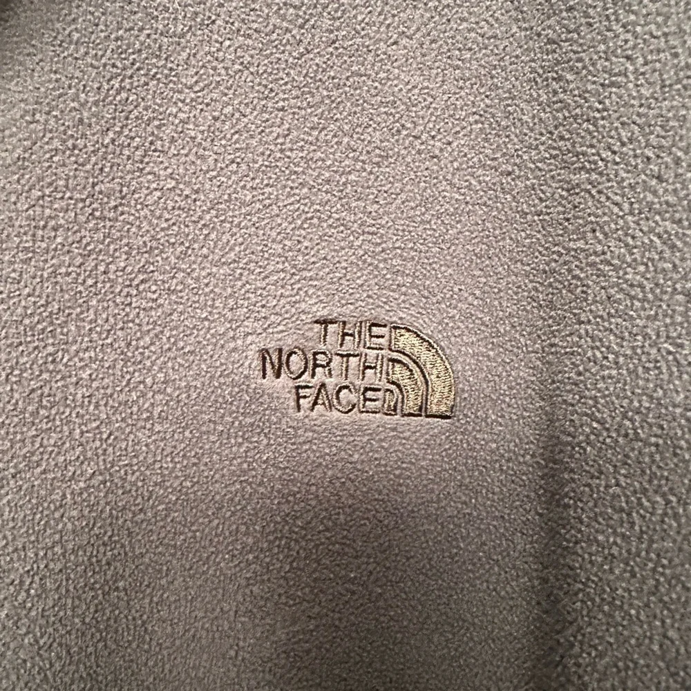 The North Face zip shoulder logo