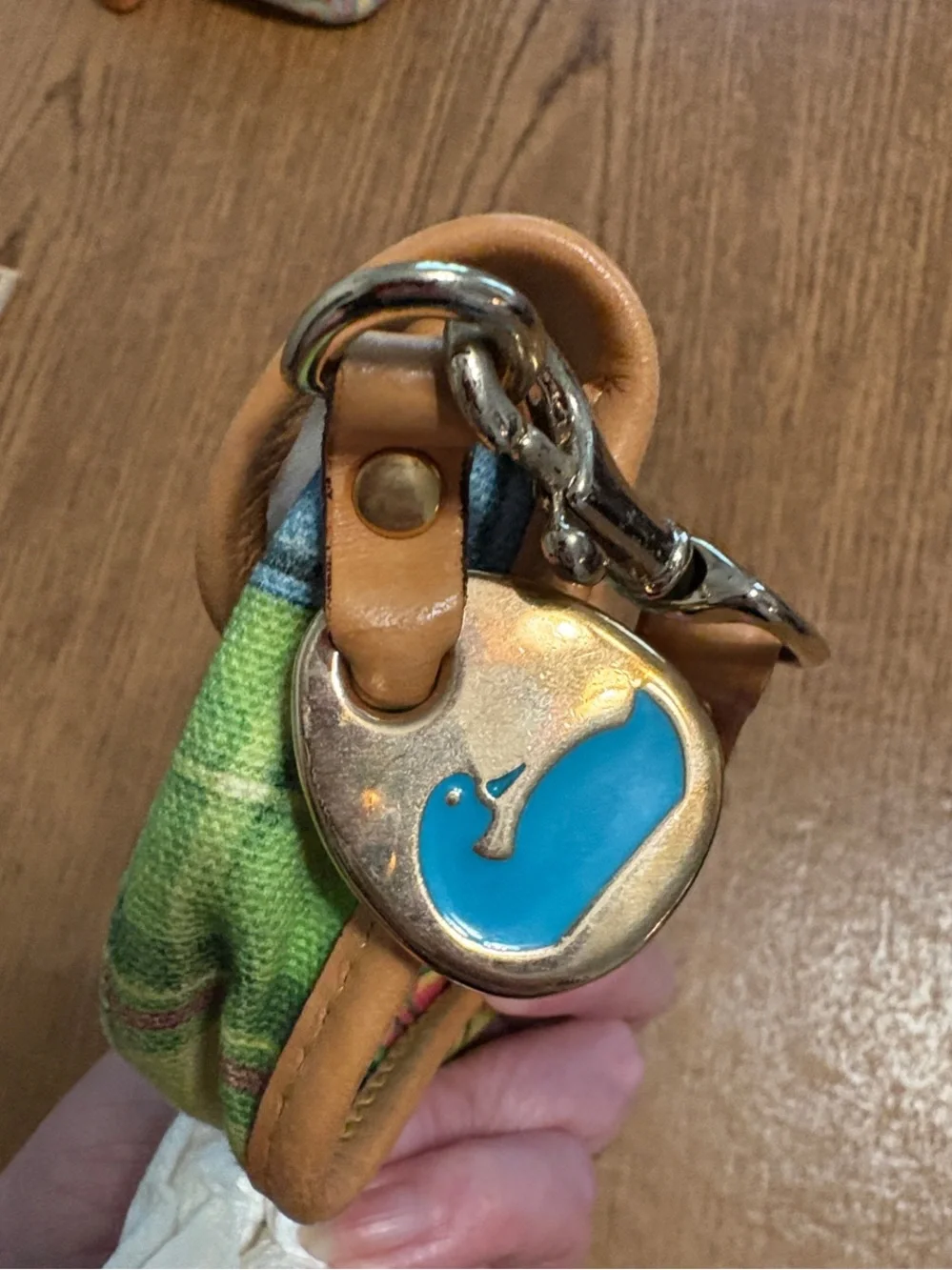 Dooney & Bourke trim closure tab
