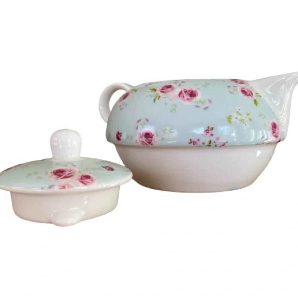 Small teapot with it’s own cup, charming, blue with roses, no flaws