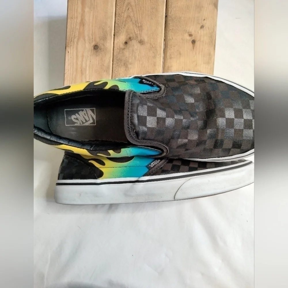 Vans slip on shoe. Size 7. Black  with blue/green and yellow🔥 running down side