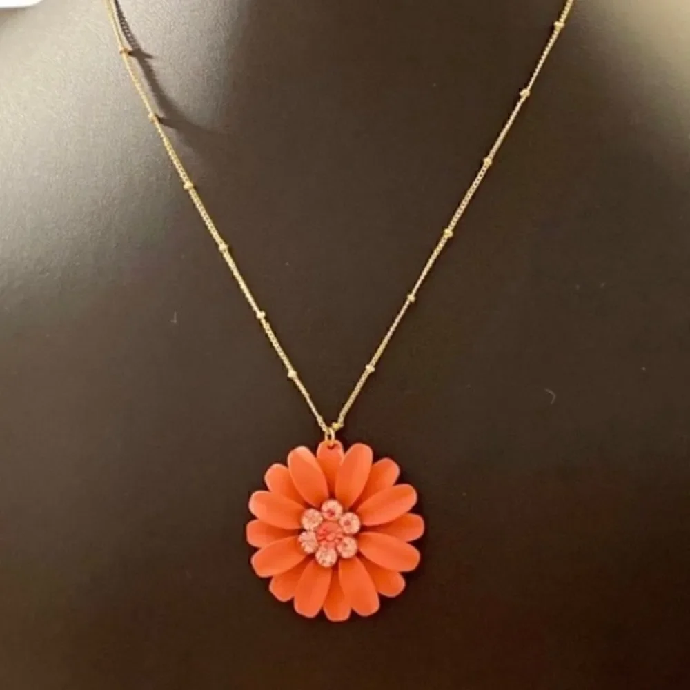 Beautiful Orange Flower Necklace on a delicate looking gold toned chain.