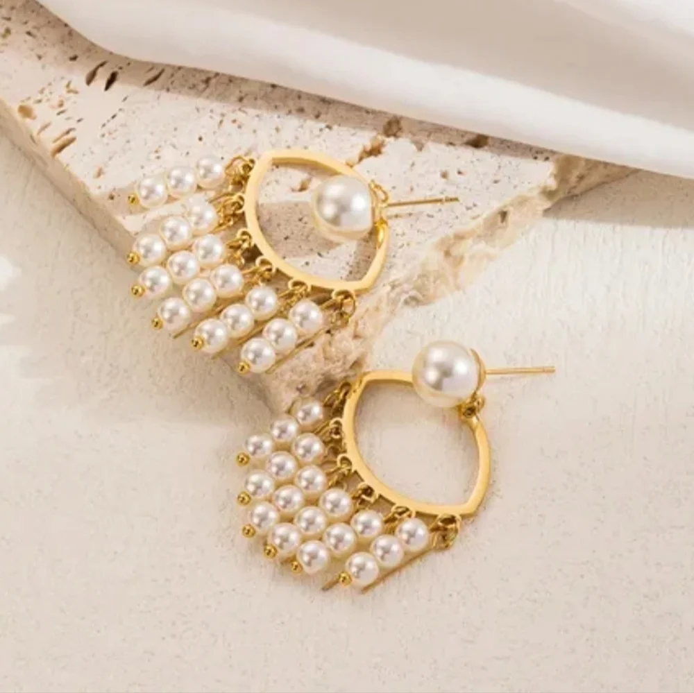 Stainless steel gold tone pearl evil eye earrings