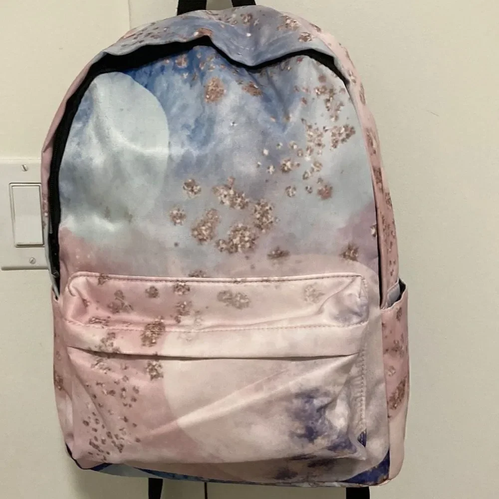 Yin Lang Nylon Backpack by Soundbyte in Pink & blue pattern.