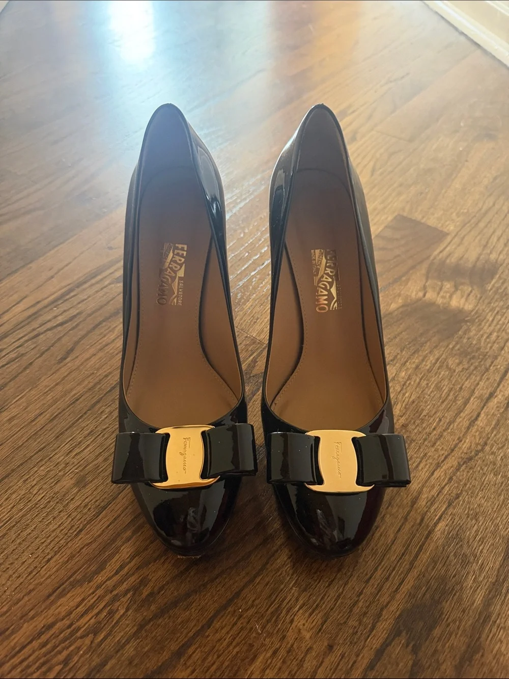 Salvatore Ferragamo Black Patent Vara Bow Pumps with Gold Plaque Accent