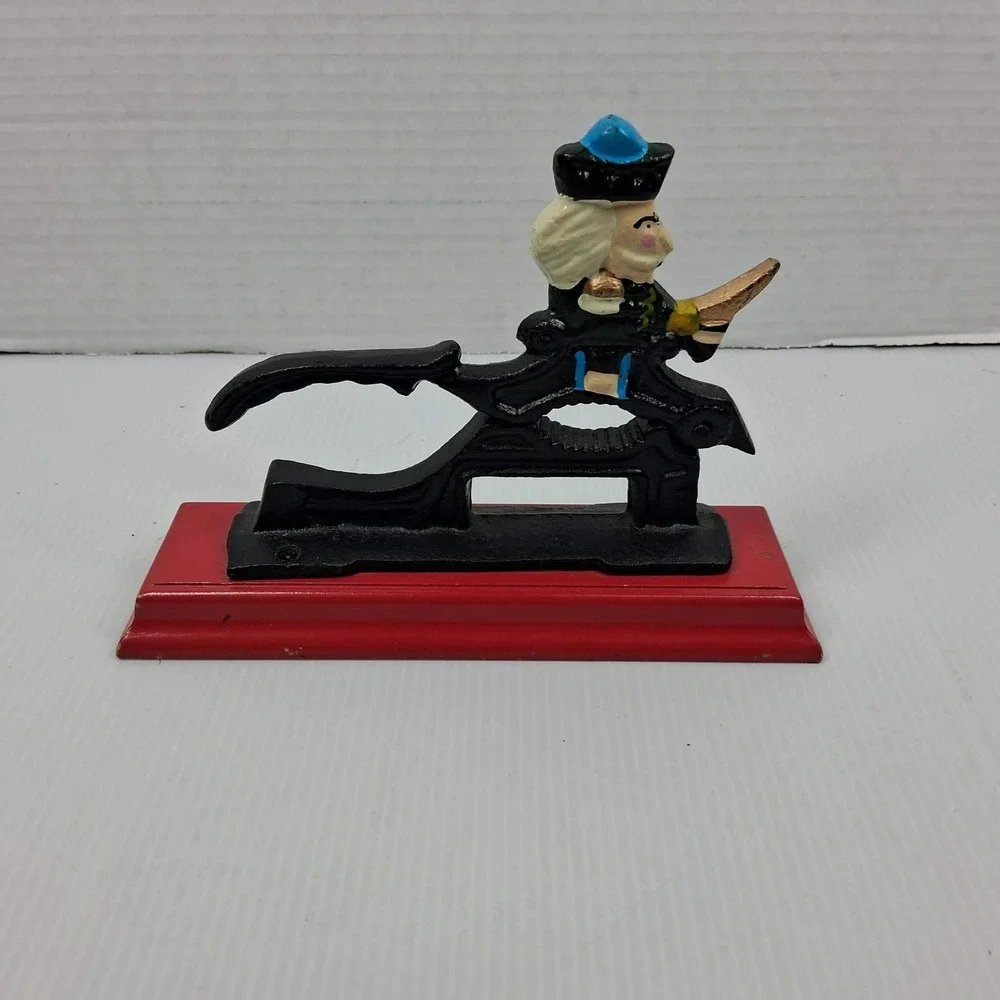 Vintage Cast Iron Mechanical Nutcracker Soldier Figure on Red Wood‎ Base Black
