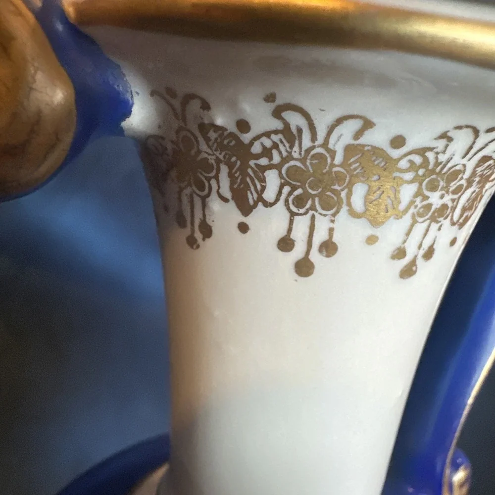 Antique porcelain urn lamp with grape-picking scene.