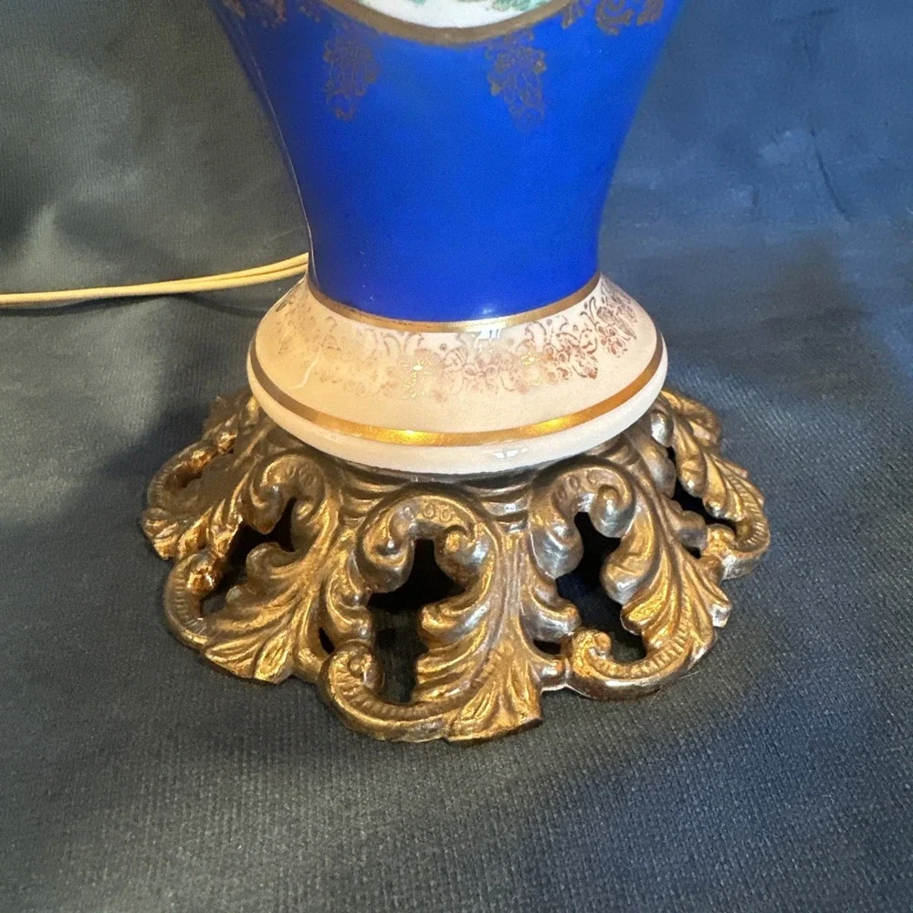 Antique porcelain urn lamp with grape-picking scene.