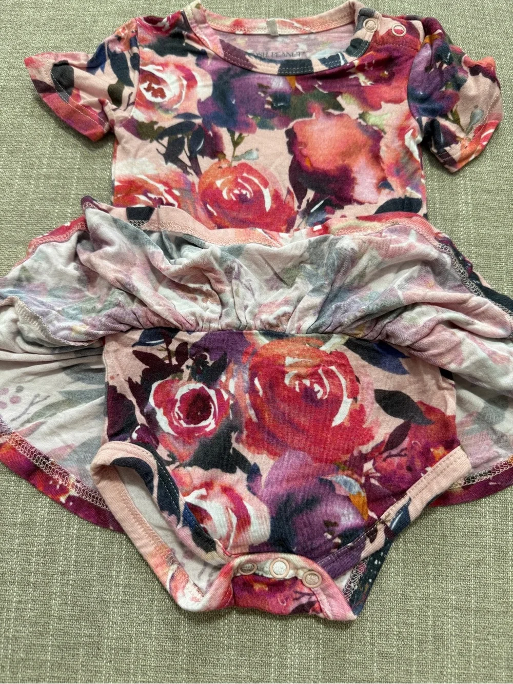 Posh Peanut twirl bodysuit features a Dusk Rose floral print 0-3M
