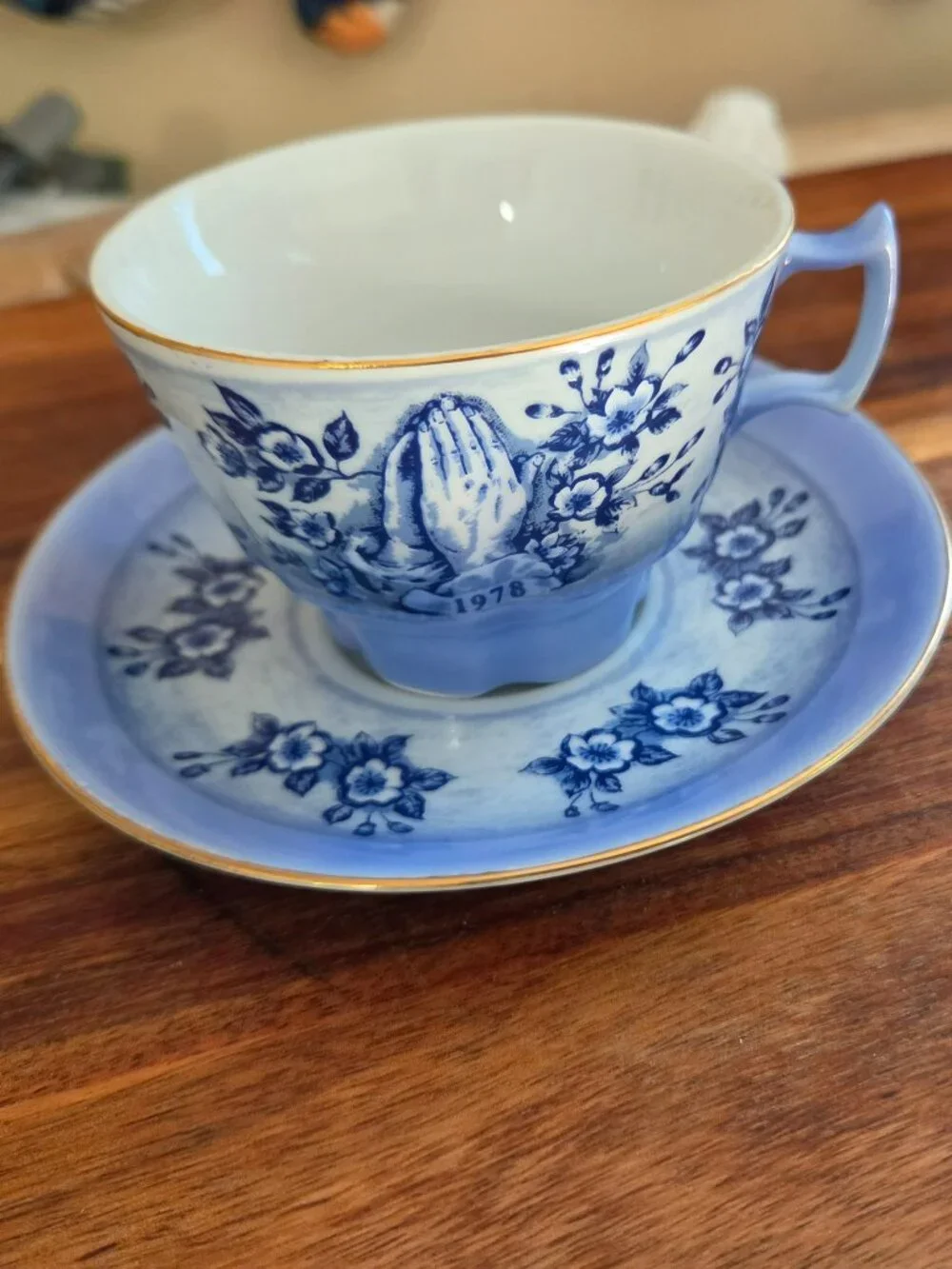vintage teacup with praying hands blue and white toile pattern