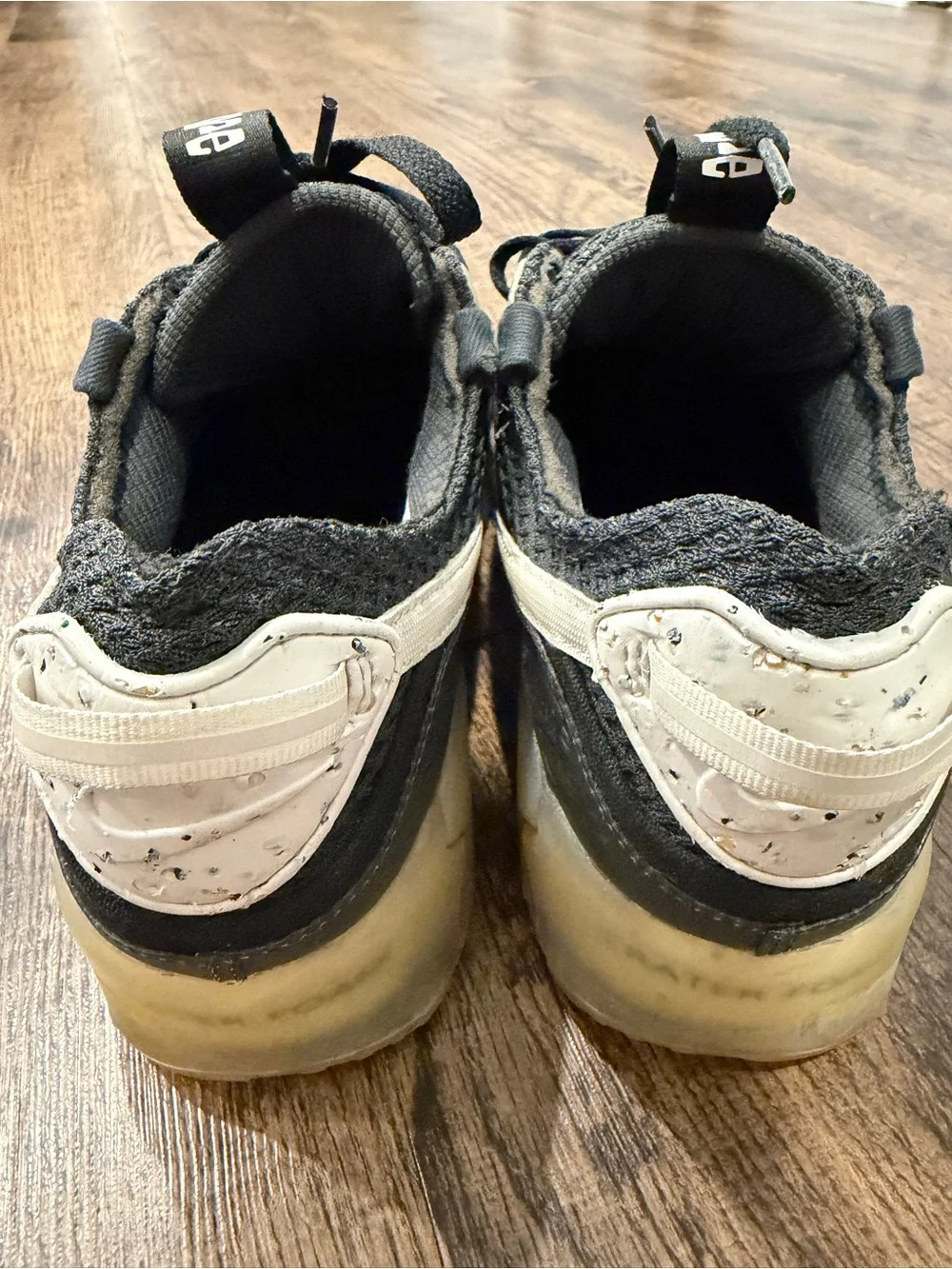 Nike Black Sneaker with White Swoosh and Yellowed Midsole