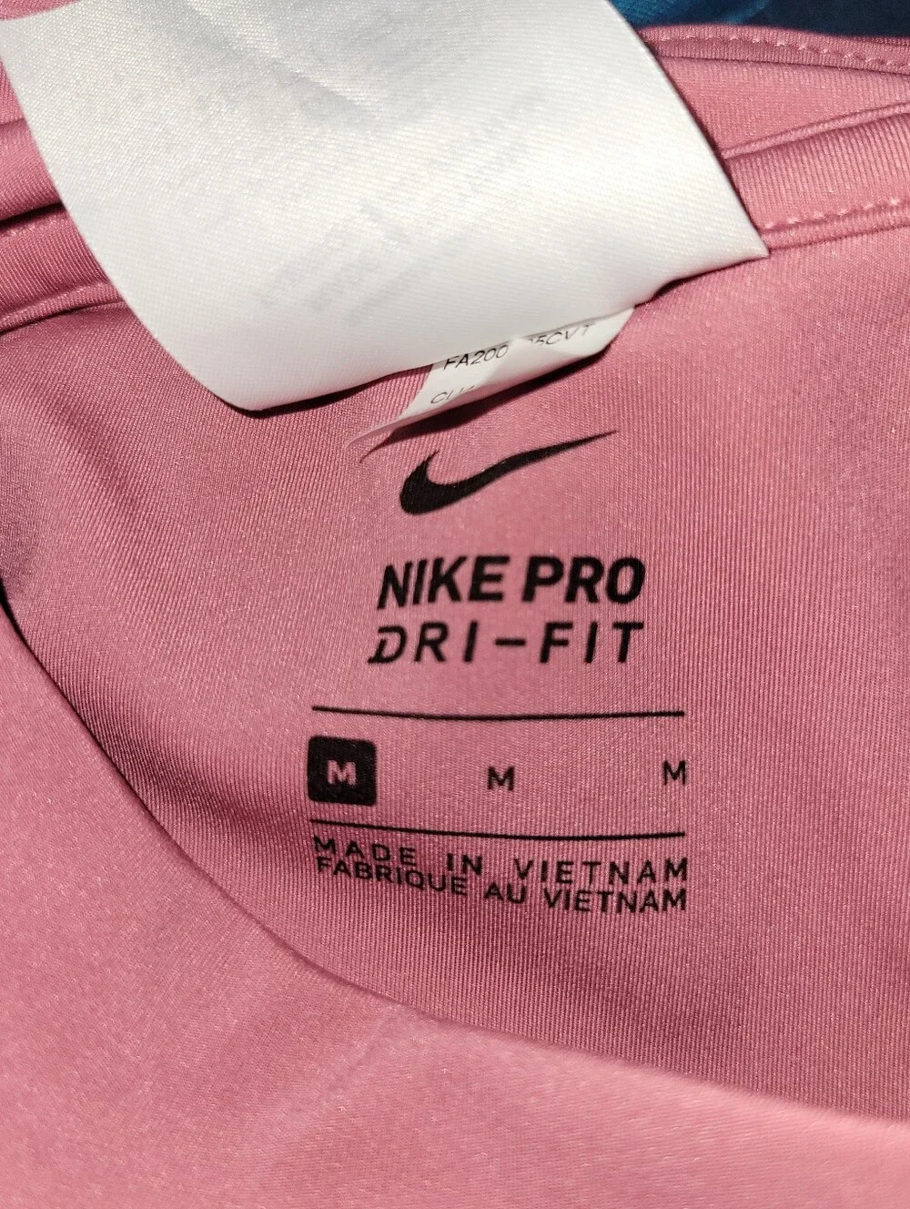 pink Nike Pro Dri-FIT crop top featuring distinctive side-cutout details