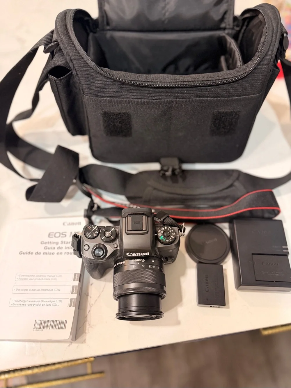 Canon Black Mirrorless Camera with Black Lens and Accessories
