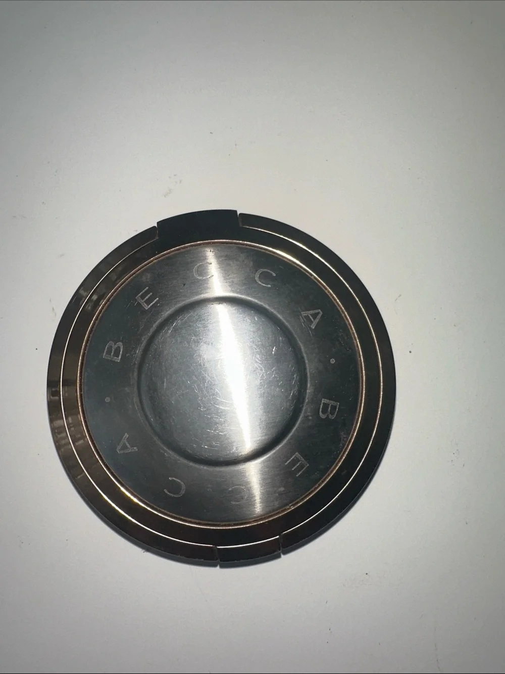 BECCA Round Metallic Compact in Silver and Rose Gold Accent