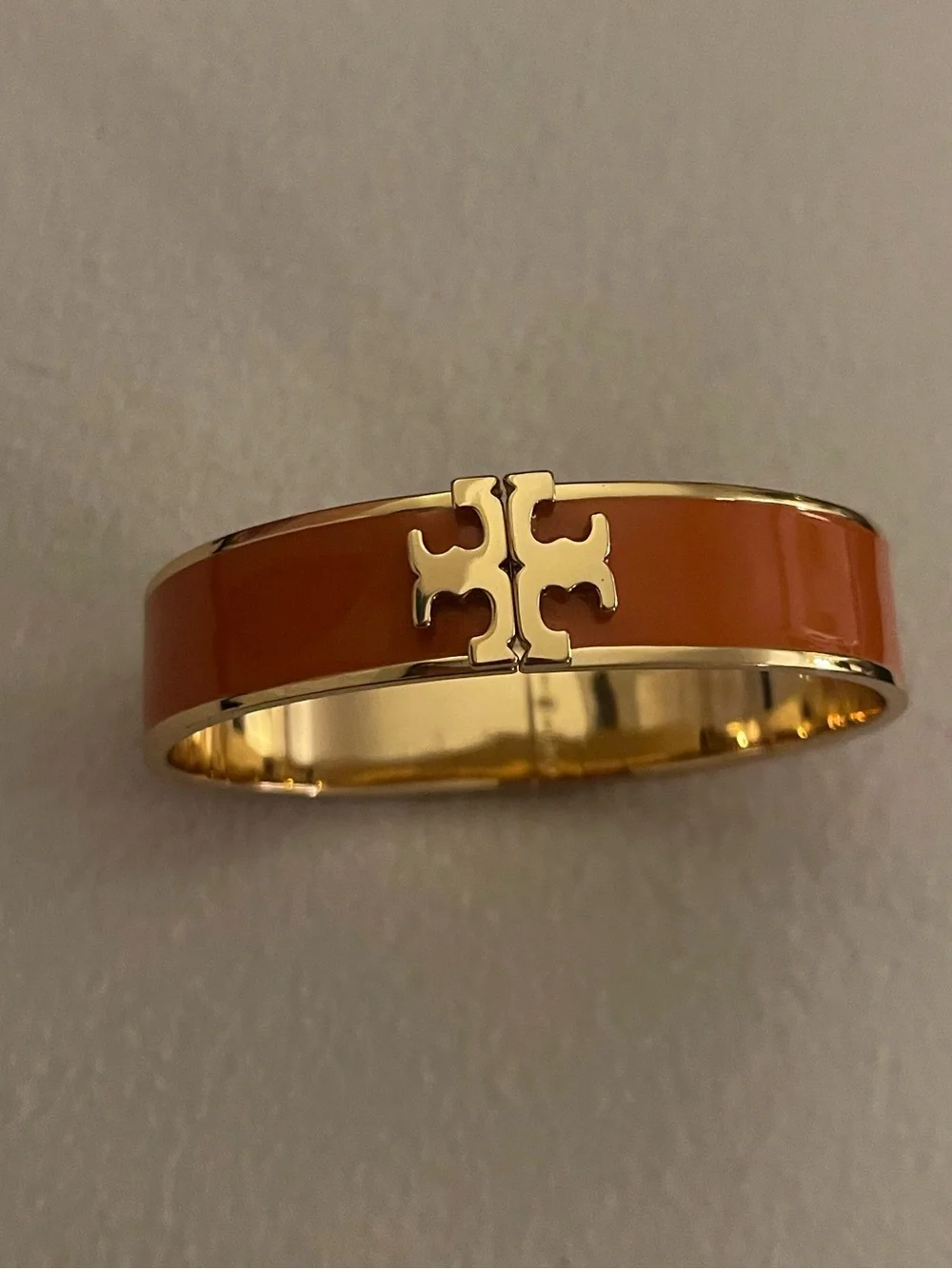Tory Burch Gold-Tone Bangle Bracelet with Orange Enamel Logo Accent