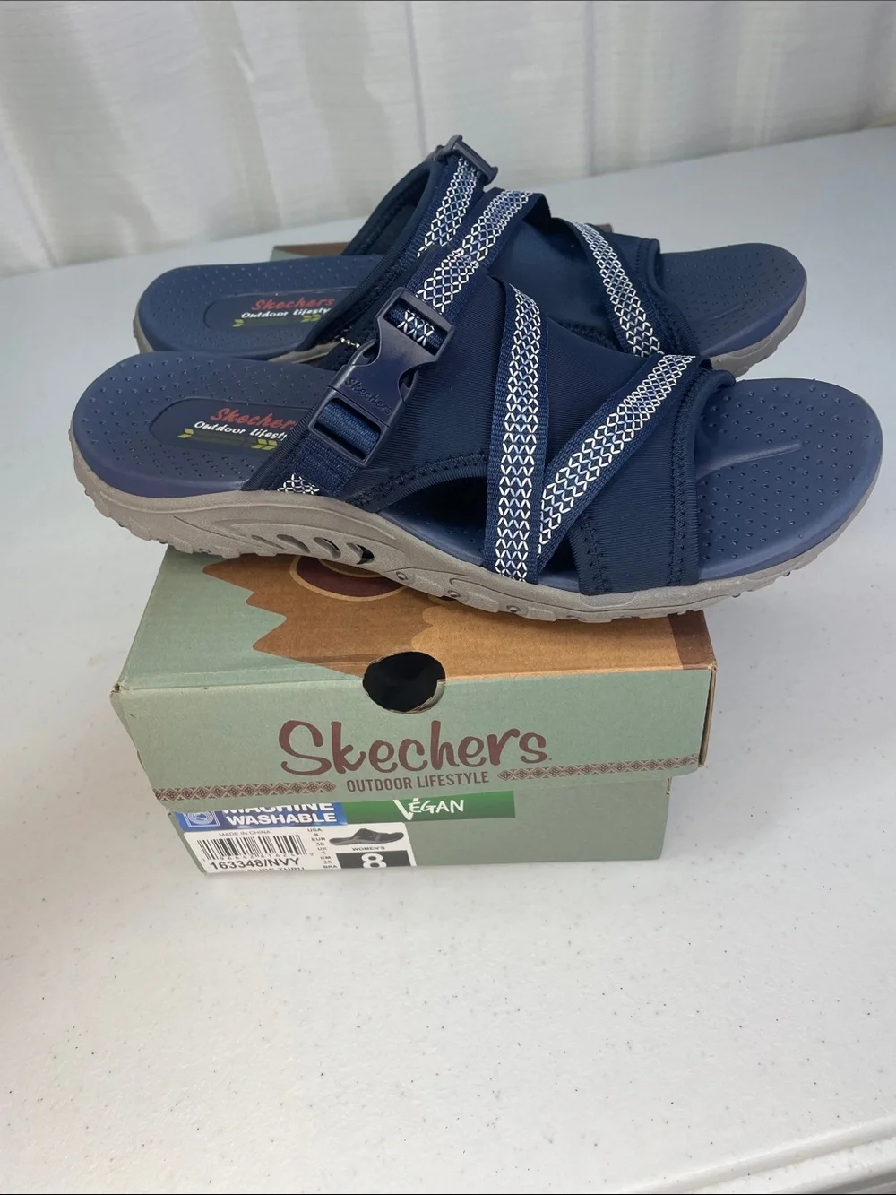 Skechers women’s Navy and White Slip-On Sport Sandals