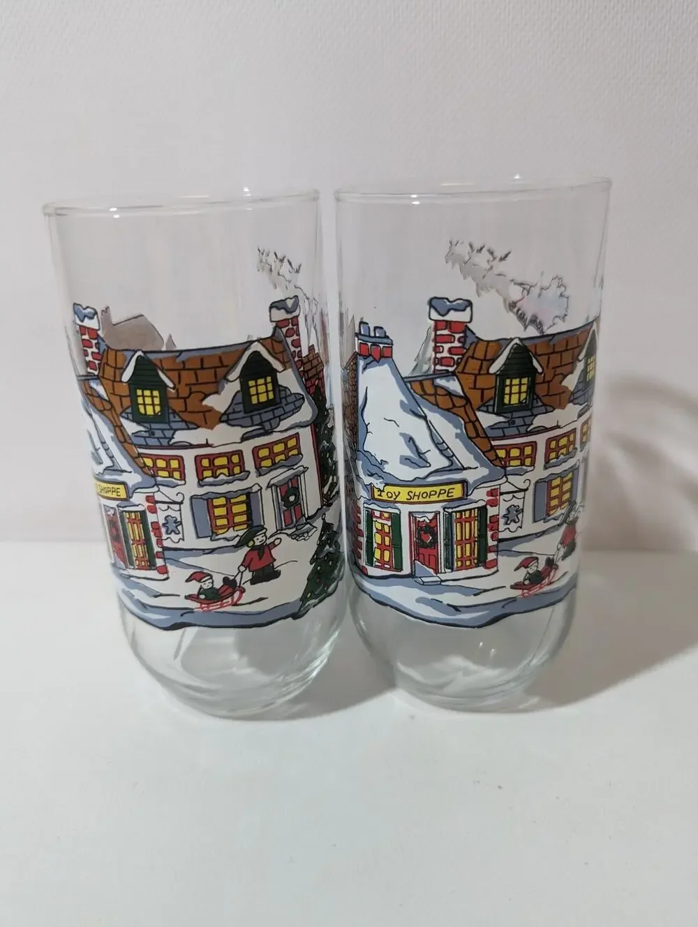 2 Coca Cola Classic glass Christmas Scene, Toy Shoppe, snowman, Santa, Coke VTG