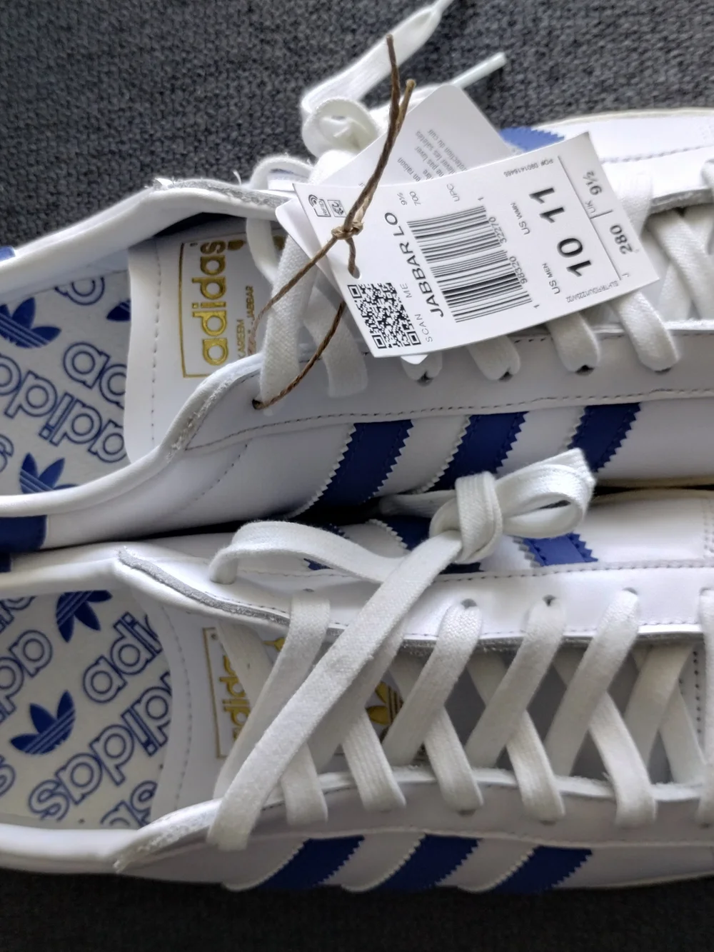 adidas White Sneakers with Blue Accents and Black Logo