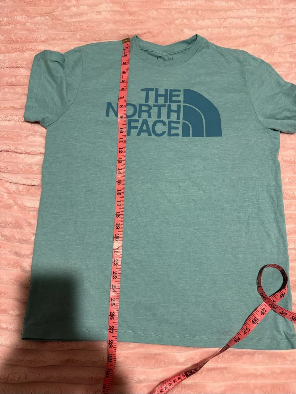 The North Face teal neck pit