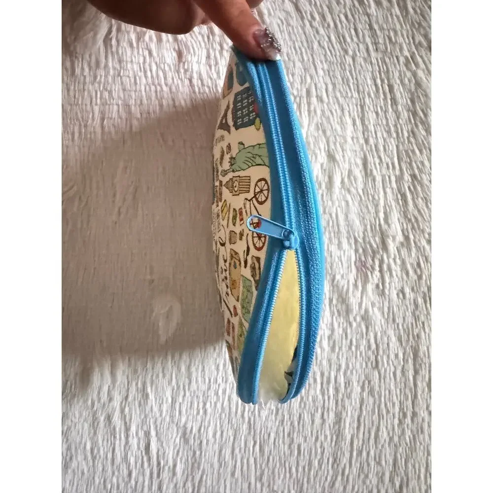 Travel-themed makeup bag/pencil pouch blue trim and travel-related illustrations