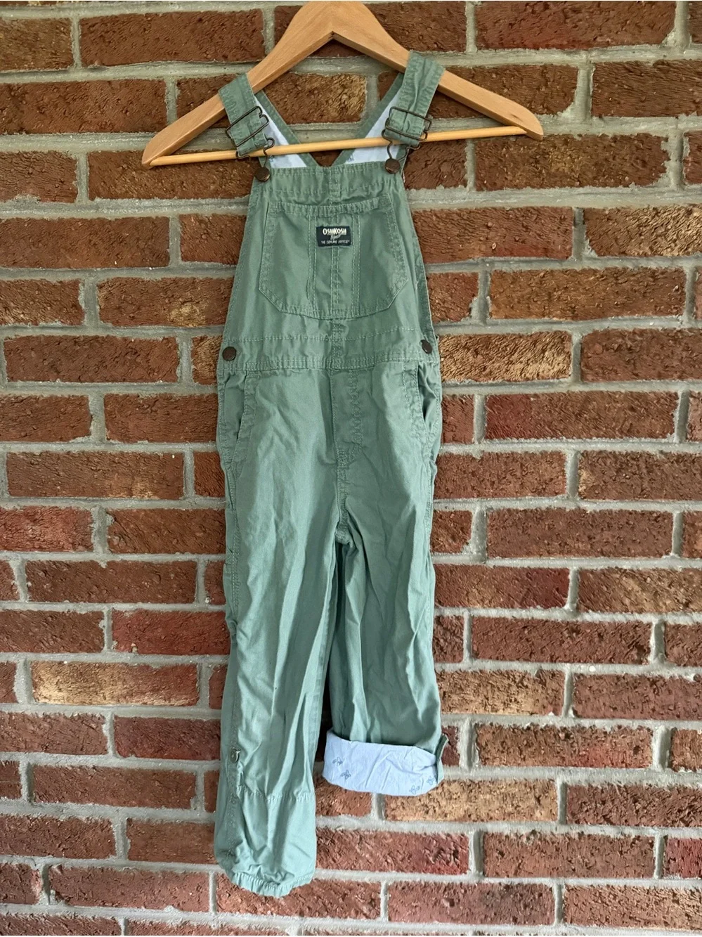 OshKosh B'gosh Kids Green Overalls. Airplanes on inside.  5T size.