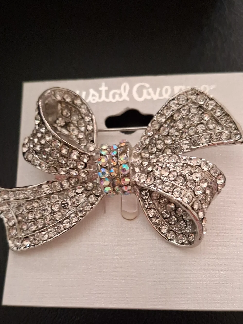 Crystal-Embellished Silver Bow Pin with Iridescent Center