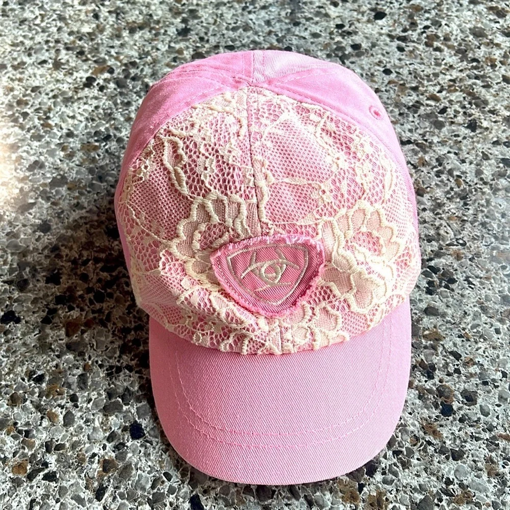 Ariat elastic back cap child’s pink‎ with white lace and logo on front .