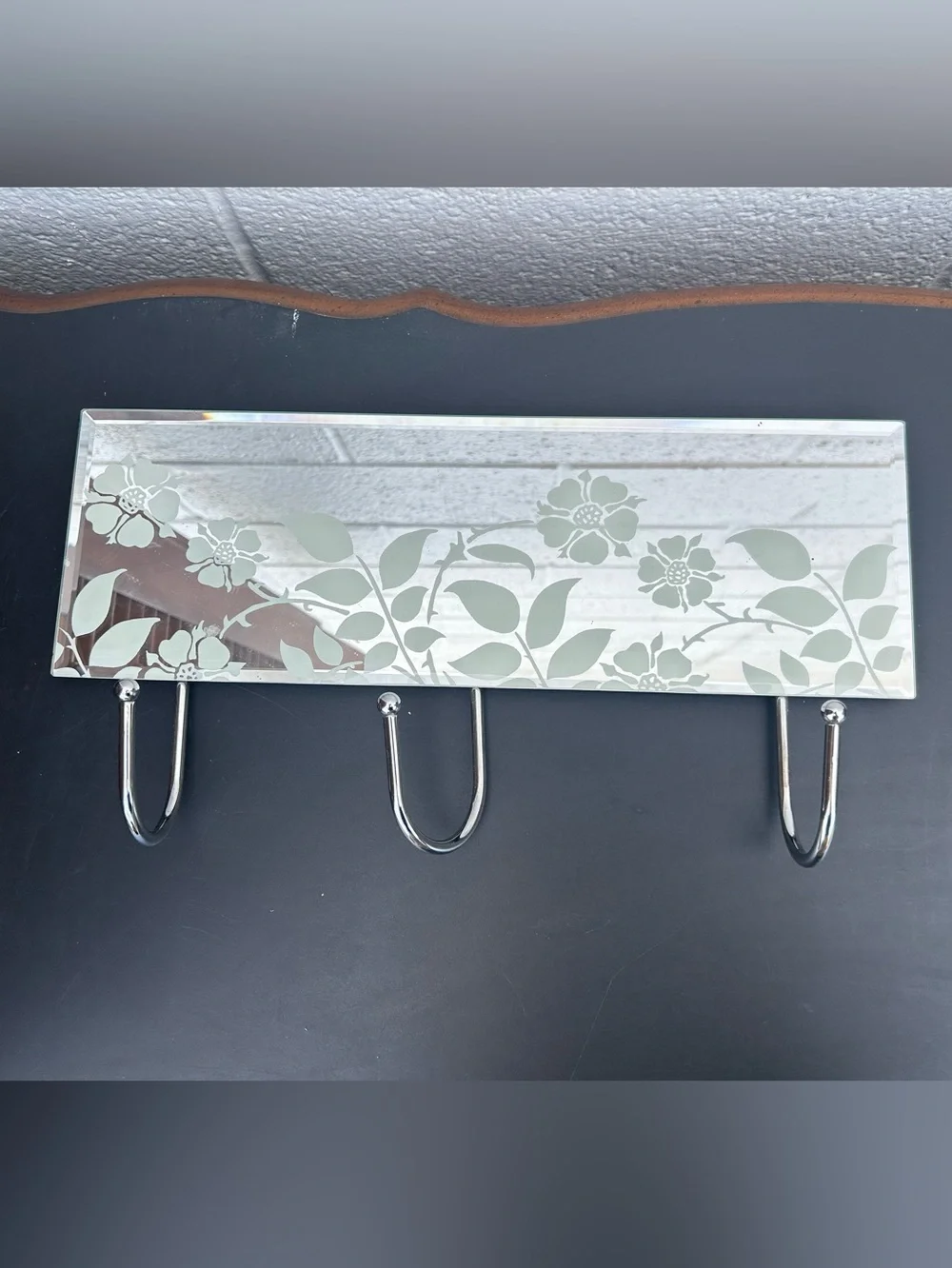 glass mirror coat rack featuring three chrome metal hooks and a delicate frosted